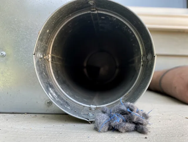 Willoughby Dryer Vent Cleaning technician using specialized equipment to clear severe dryer vent blockage in Willoughby